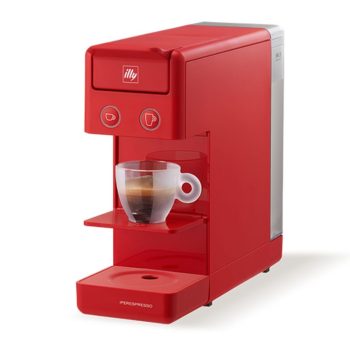 Red Illy espresso machine brews into a small glass cup placed under the spout