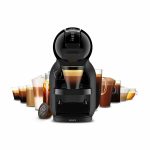 Krups compact black coffee machine with an espresso in the cup, surrounded by assorted coffee cups and capsules.